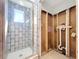 Bathroom with new glass-enclosed shower and fixtures, featuring neutral tile and bright window at 4941 Waterside Dr, Port Richey, FL 34668