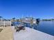 Waterfront property with a boat lift and boat, picnic table, and a fenced yard at 4941 Waterside Dr, Port Richey, FL 34668