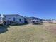 Back exterior of home showing a fenced backyard and screened in patio at 4941 Waterside Dr, Port Richey, FL 34668