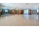 Open-concept living room being remodeled with terrazzo flooring and sliding glass doors to a bright outdoor space at 4941 Waterside Dr, Port Richey, FL 34668