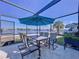 Outdoor patio with table, chairs, umbrella, and waterfront view at 4941 Waterside Dr, Port Richey, FL 34668