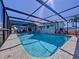 Backyard pool with screen enclosure and view of the home's exterior on a sunny day at 4941 Waterside Dr, Port Richey, FL 34668