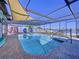 Enclosed swimming pool with clear blue water, shaded by a metal frame and view of the canal at 4941 Waterside Dr, Port Richey, FL 34668