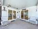 Covered porch featuring several white rocking chairs and sliding doors at 4941 Waterside Dr, Port Richey, FL 34668