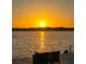 Golden sunset view from the dock, reflected on the calm waters with silhouetted trees in the distance at 4941 Waterside Dr, Port Richey, FL 34668