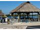 Thatched-roof waterfront bar and restaurant overlooking the picturesque harbor waters and boat dock at 4941 Waterside Dr, Port Richey, FL 34668