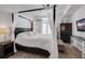 Beautiful main bedroom featuring a four poster bed with draping and natural light from the french doors at 501 Knights Run Ave # 1203, Tampa, FL 33602