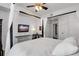 Stylish bedroom features a ceiling fan, TV, desk and chair and white walls at 501 Knights Run Ave # 1203, Tampa, FL 33602