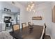 Elegant dining room with modern lighting, wine rack and open to kitchen area at 501 Knights Run Ave # 1203, Tampa, FL 33602