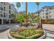 Beautiful condo entrance featuring a fountain, lush landscaping, and a well-maintained exterior at 501 Knights Run Ave # 1203, Tampa, FL 33602