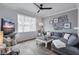 Cozy living room featuring a plush gray couch, a stylish coffee table, and natural light at 501 Knights Run Ave # 1203, Tampa, FL 33602