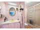 Pink bathroom featuring walk in shower, unique fixtures, and vintage charm at 5125 Jo St, Zephyrhills, FL 33542