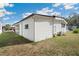 Exterior view of home highlighting the yard and landscaping at 5125 Jo St, Zephyrhills, FL 33542