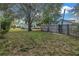 A sprawling backyard with mature trees and a wood fence, perfect for outdoor activities and privacy at 535 28Th N Ave, St Petersburg, FL 33704