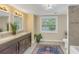 Bright bathroom with double vanity, tan tile floors, and a tiled shower and tub at 535 28Th N Ave, St Petersburg, FL 33704