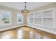 Well-lit dining room features hardwood floors, a modern chandelier, and multiple windows at 535 28Th N Ave, St Petersburg, FL 33704