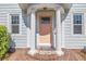 Close-up of the home's front door, framed by white columns and a welcoming welcome mat at 535 28Th N Ave, St Petersburg, FL 33704