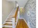 Hallway with staircase featuring hardwood floors, decorative wallpaper, and a charming display niche at 535 28Th N Ave, St Petersburg, FL 33704