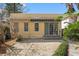 The back patio with a small awning, paved bricks, and a doorwall to the home at 5807 N Branch Ave, Tampa, FL 33604