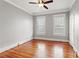 Bedroom featuring hardwood flooring, neutral paint, and windows for natural light at 5807 N Branch Ave, Tampa, FL 33604