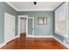 Stylish bedroom featuring a large window, hardwood floors, and neutral-colored walls at 5807 N Branch Ave, Tampa, FL 33604