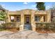 Charming yellow stucco bungalow featuring a welcoming front porch and well-maintained landscaping at 5807 N Branch Ave, Tampa, FL 33604