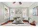 Cozy living room with wood floors, a brick fireplace, ceiling fan and natural light at 5807 N Branch Ave, Tampa, FL 33604