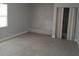 Spacious bedroom with white brick accent wall and closet with striped curtains at 6008 Memorial Hwy, Tampa, FL 33615