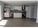 Modern kitchen with stainless steel appliances, white cabinets, tile backsplash, and view of the dining area at 6008 Memorial Hwy, Tampa, FL 33615