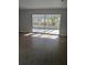 Living room with large sliding glass doors leading to the outdoor patio with tiled floor and a large window at 6008 Memorial Hwy, Tampa, FL 33615