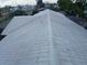 Aerial view of a gray tile roof with a ridge cap and a view of the surrounding neighborhood at 6008 Memorial Hwy, Tampa, FL 33615