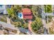 An overhead view of a red-roofed property with a pool, surrounded by lush landscaping and neighboring homes at 612 Montezuma Dr, Bradenton, FL 34209