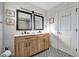 Bathroom featuring a double vanity, stylish mirrors, and patterned tile floor at 612 Montezuma Dr, Bradenton, FL 34209