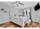 Bedroom with shell decorations, bed, bench, and wood-look tile flooring at 612 Montezuma Dr, Bradenton, FL 34209