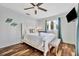 Bedroom with shell decorations, bed, bench, and wood-look tile flooring at 612 Montezuma Dr, Bradenton, FL 34209