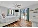 Bright bedroom featuring a bed with views from the plentiful windows with wood-look tile flooring at 612 Montezuma Dr, Bradenton, FL 34209