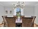 Dining room with a wood table, wicker chairs, and modern light fixture that overlooks the backyard pool at 612 Montezuma Dr, Bradenton, FL 34209