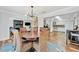 Open-concept living area featuring a dining room with wicker chairs, a chandelier, and a kitchen view at 612 Montezuma Dr, Bradenton, FL 34209