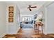 Hallway with coastal wall art leading into a bright living room with stylish decor at 612 Montezuma Dr, Bradenton, FL 34209