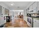 Bright kitchen with stainless steel appliances, wood floors and an adjacent dining area at 612 Montezuma Dr, Bradenton, FL 34209