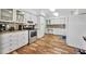 Well-lit kitchen with stainless steel appliances, mosaic backsplash, and beautiful wood flooring at 612 Montezuma Dr, Bradenton, FL 34209