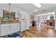 Spacious kitchen with wood floors and white appliances that opens up to the dining area at 612 Montezuma Dr, Bradenton, FL 34209