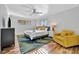 Bright main bedroom with hardwood floors, a ceiling fan, and a cozy yellow chair at 612 Montezuma Dr, Bradenton, FL 34209