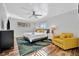 Bright main bedroom with hardwood floors, a ceiling fan, and a cozy yellow chair at 612 Montezuma Dr, Bradenton, FL 34209