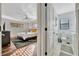 Bright main bedroom with a ceiling fan, hardwood floors, and an ensuite bathroom at 612 Montezuma Dr, Bradenton, FL 34209