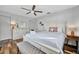 Bright bedroom with hardwood floors, white furnishings, and a ceiling fan at 612 Montezuma Dr, Bradenton, FL 34209