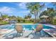 Relaxing backyard pool with in-pool lounge chairs, perfect for soaking up the sun on a beautiful day at 612 Montezuma Dr, Bradenton, FL 34209