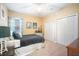 Cozy bedroom featuring neutral carpet, white closets, a comfy bed, and charming decor at 6411 Grenada Island Ave, Apollo Beach, FL 33572