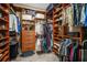 Spacious walk-in closet with custom shelving and organization system at 6411 Grenada Island Ave, Apollo Beach, FL 33572