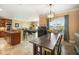 Open-concept kitchen and dining area with tile floors, modern lighting and an adjacent living space at 6411 Grenada Island Ave, Apollo Beach, FL 33572